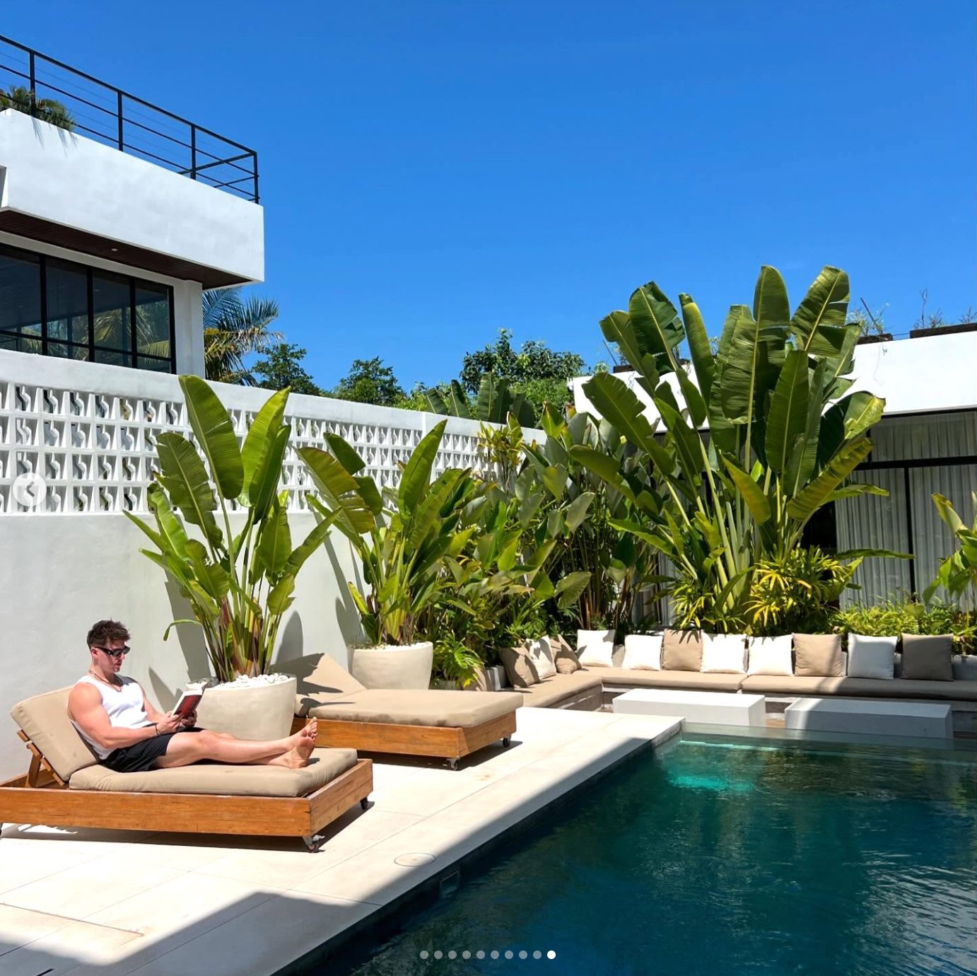 Lachie reading by the pool in Bali