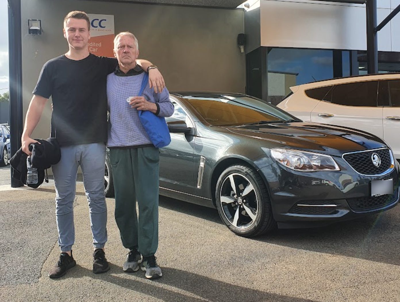 Lachie and his dad with the car Lachie bought him